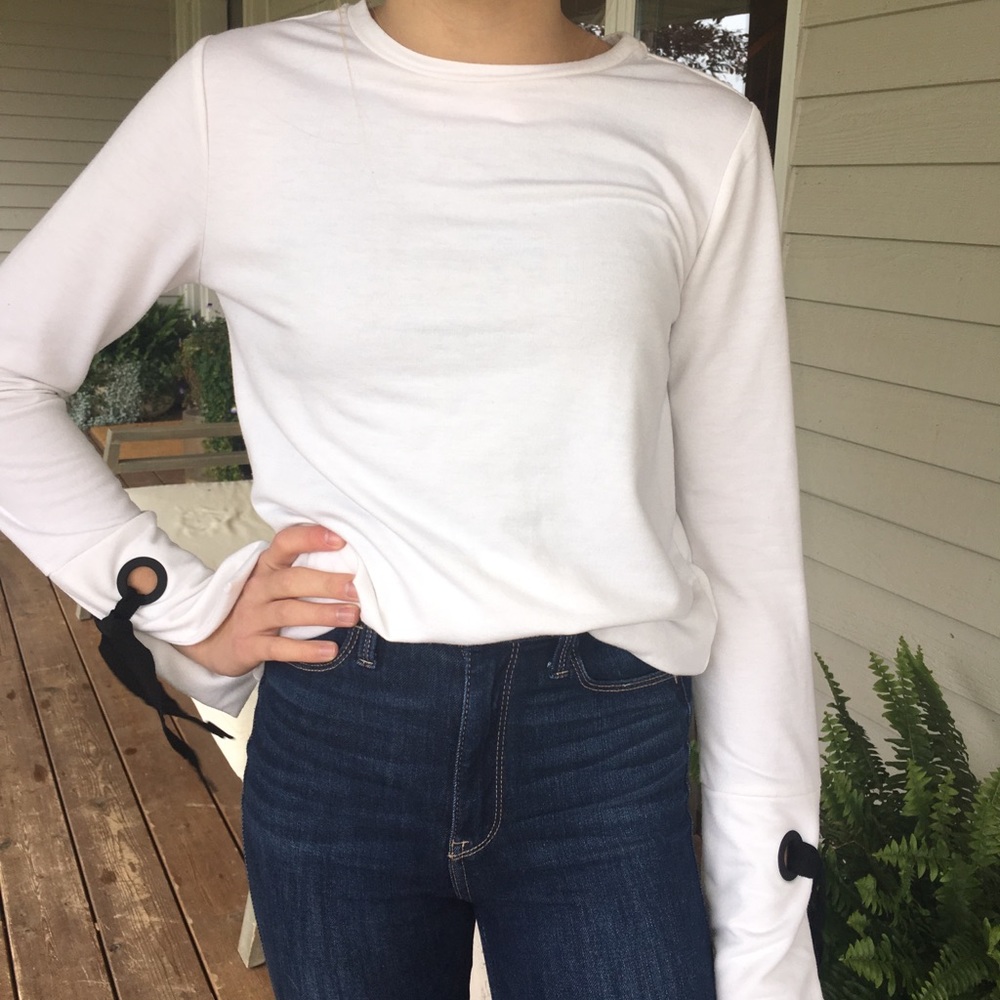 white longsleeve with ties on the sleeves